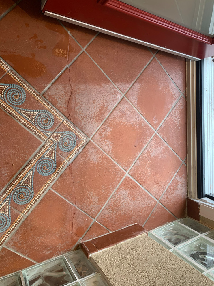 Small mediterranean mudroom in Toronto with terra-cotta floors and red floor.