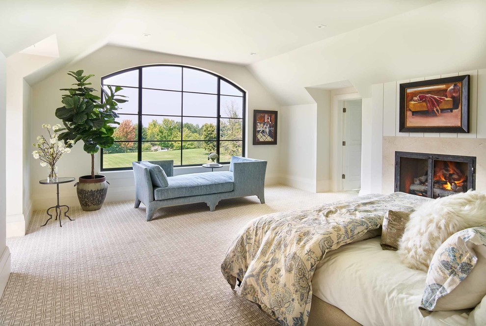 This is an example of a large traditional master bedroom in Denver with white walls, carpet and a standard fireplace.