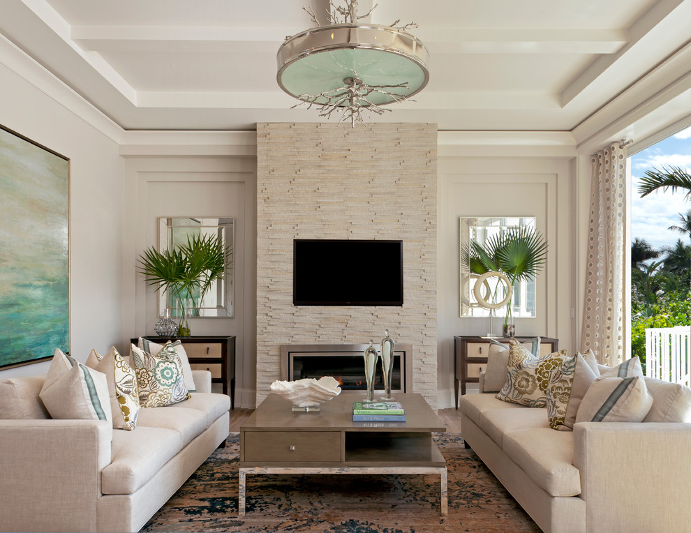 This is an example of a beach style formal living room in Miami with beige walls and a wall-mounted tv.