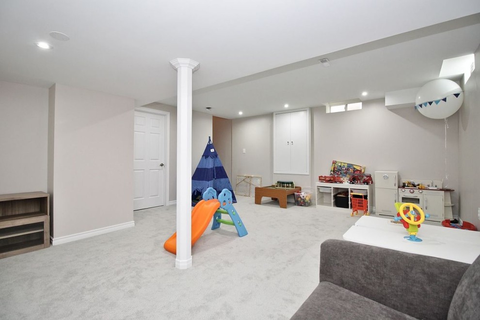 Design ideas for a mid-sized transitional fully buried basement in Toronto with beige walls, carpet, no fireplace and grey floor.