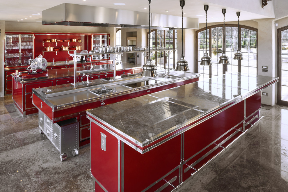 This is an example of an expansive industrial galley open plan kitchen in Florence with stainless steel benchtops and multiple islands.