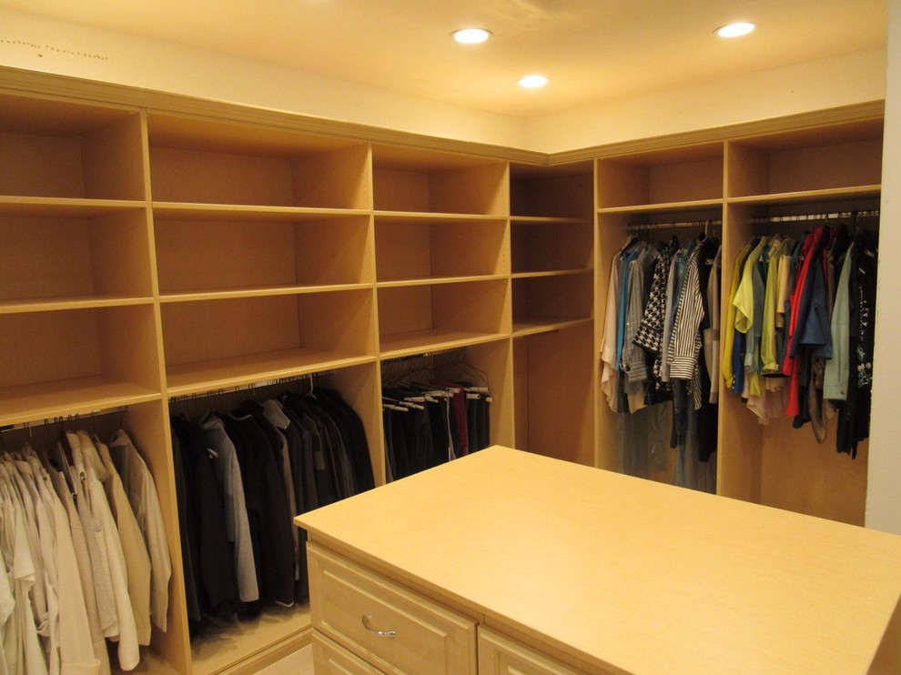 Photo of a large transitional gender-neutral walk-in wardrobe in Birmingham with raised-panel cabinets and light wood cabinets.