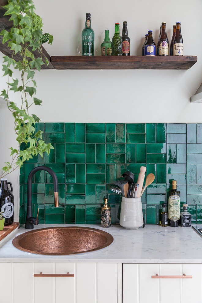 Inspiration for a small eclectic l-shaped separate kitchen in London with white cabinets, marble benchtops, green splashback, ceramic splashback, no island, a drop-in sink and louvered cabinets.