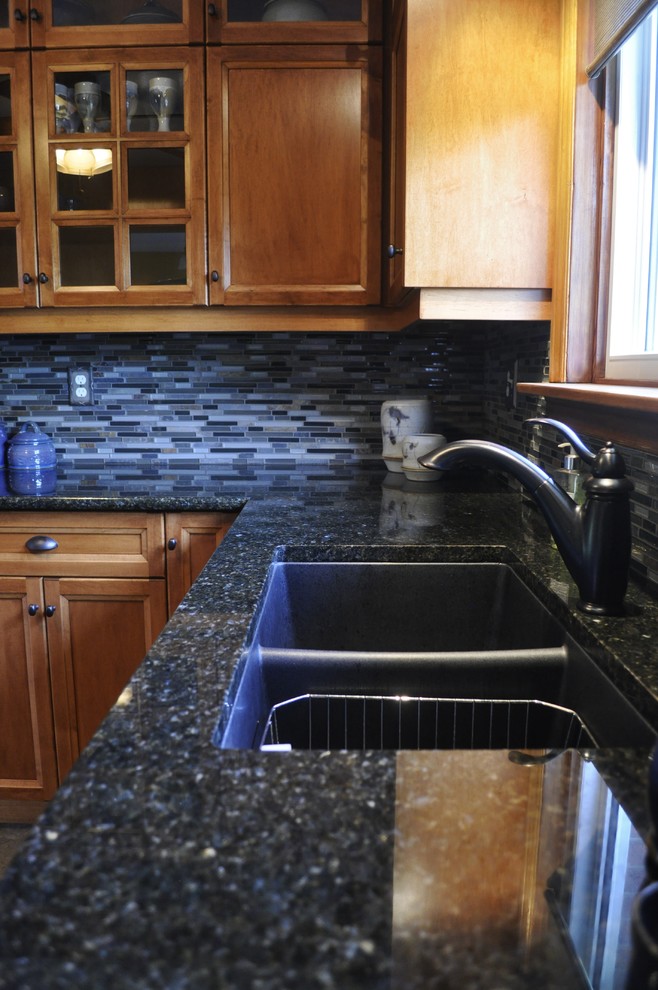 Mid-sized mountain style l-shaped kitchen photo in Toronto with an undermount sink, medium tone wood cabinets, granite countertops, blue backsplash, stainless steel appliances and no island
