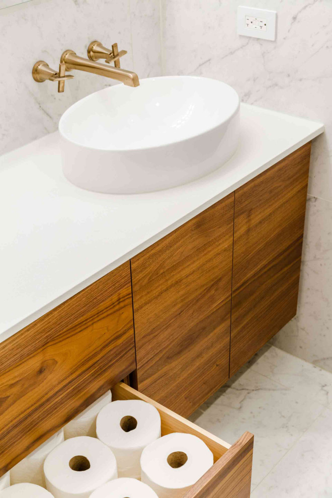 Design ideas for a mid-sized modern master bathroom in New York with flat-panel cabinets, medium wood cabinets, a one-piece toilet, white tile, porcelain tile, white walls, porcelain floors, a vessel sink, engineered quartz benchtops, white floor, a sliding shower screen, white benchtops, a niche, a single vanity and a floating vanity.