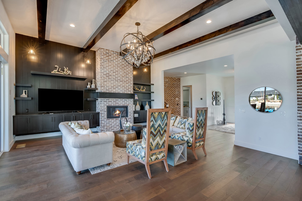 Inspiration for an expansive transitional open concept living room in Boise with white walls, medium hardwood floors, a ribbon fireplace, a brick fireplace surround, a freestanding tv and brown floor.