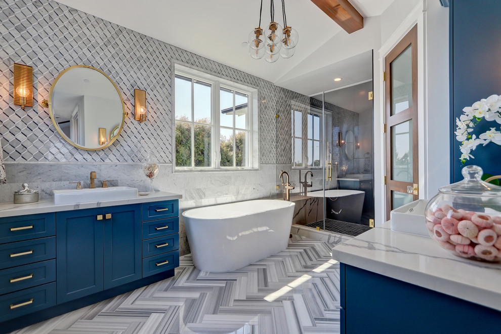 Photo of a beach style master bathroom in Los Angeles with shaker cabinets, blue cabinets, a freestanding tub, an alcove shower, multi-coloured walls, a vessel sink, multi-coloured floor, a hinged shower door and grey benchtops.