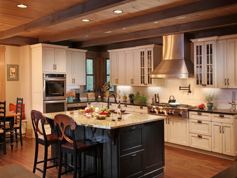 Inspiration for a rustic kitchen remodel in Atlanta with white backsplash, stainless steel appliances and an island