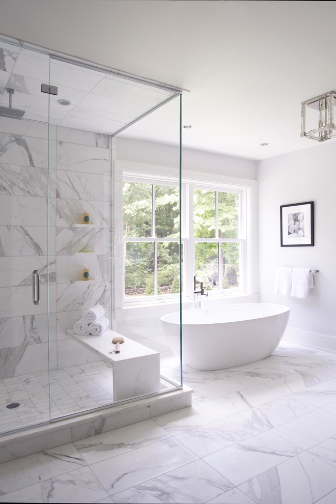 Design ideas for an expansive transitional master bathroom in New York with shaker cabinets, dark wood cabinets, a freestanding tub, a corner shower, gray tile, white tile, marble, white walls, marble floors, an undermount sink, marble benchtops, white floor and a hinged shower door.
