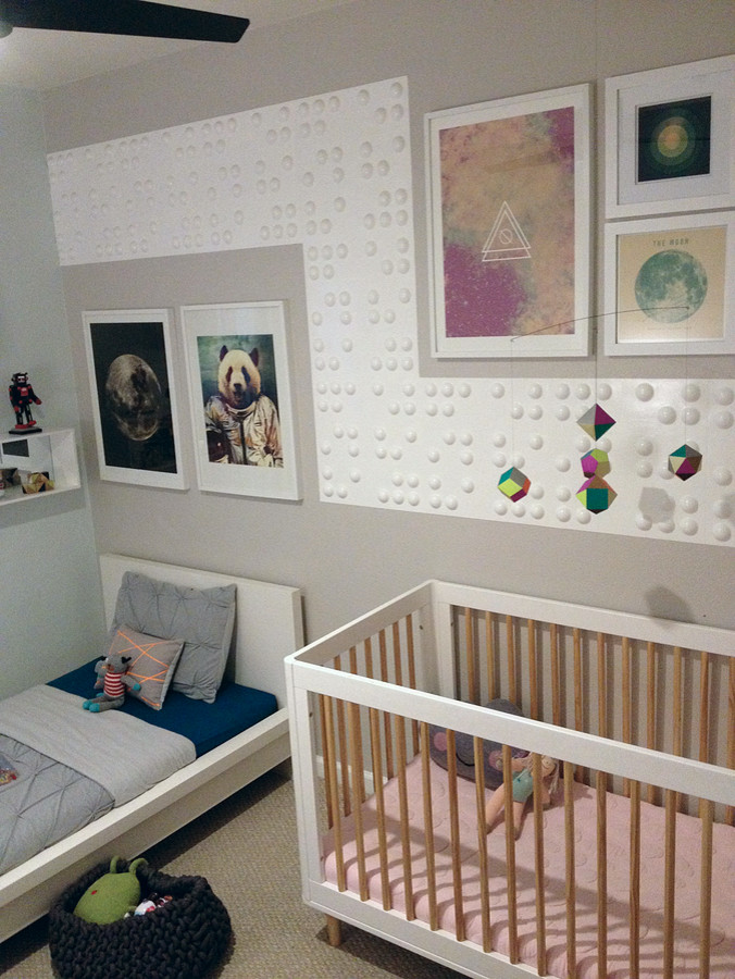 This is an example of a small contemporary gender-neutral kids' bedroom for kids 4-10 years old in San Francisco with grey walls and carpet.