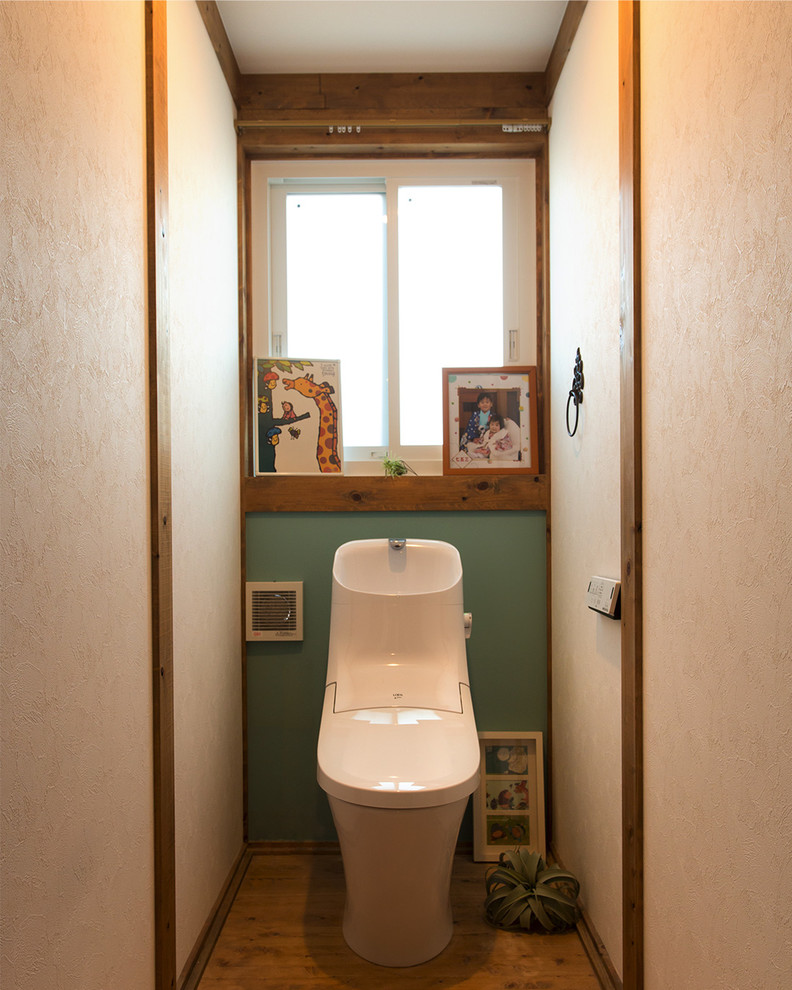 Asian powder room in Other with multi-coloured walls, medium hardwood floors and brown floor.