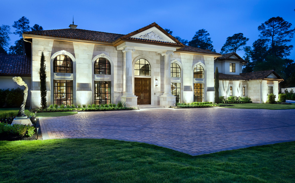 Inspiration for an expansive transitional two-storey white exterior in Houston with stone veneer.