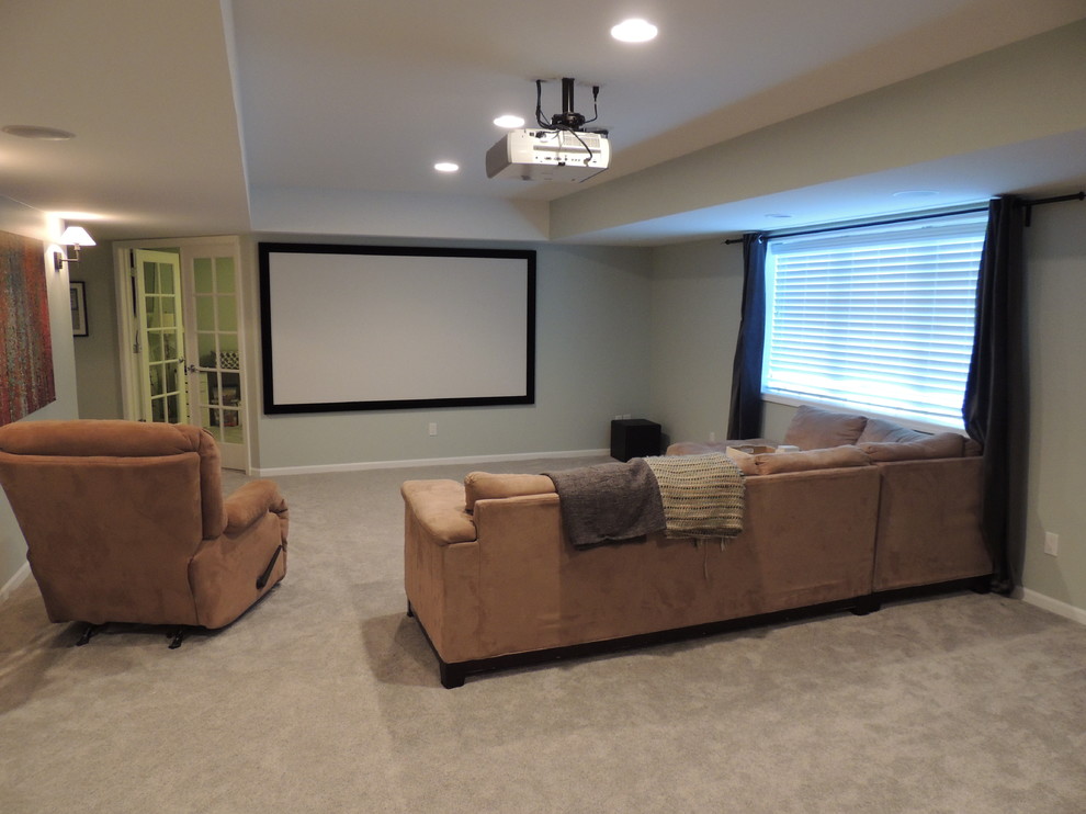 Photo of a mid-sized traditional home theatre in Detroit with grey walls and carpet.