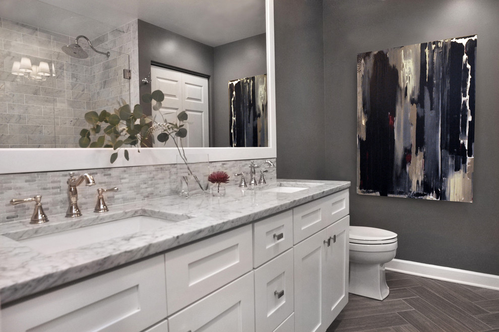 Transitional white tile and subway tile porcelain tile home design photo in Chicago with shaker cabinets, white cabinets, a two-piece toilet, gray walls, an undermount sink and marble countertops
