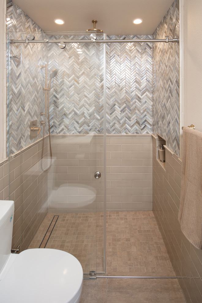 Photo of a small transitional 3/4 bathroom in San Luis Obispo with recessed-panel cabinets, grey cabinets, a curbless shower, beige tile, multi-coloured tile, subway tile, beige walls, travertine floors, an undermount sink, marble benchtops, beige floor, a sliding shower screen, grey benchtops, a single vanity and a built-in vanity.