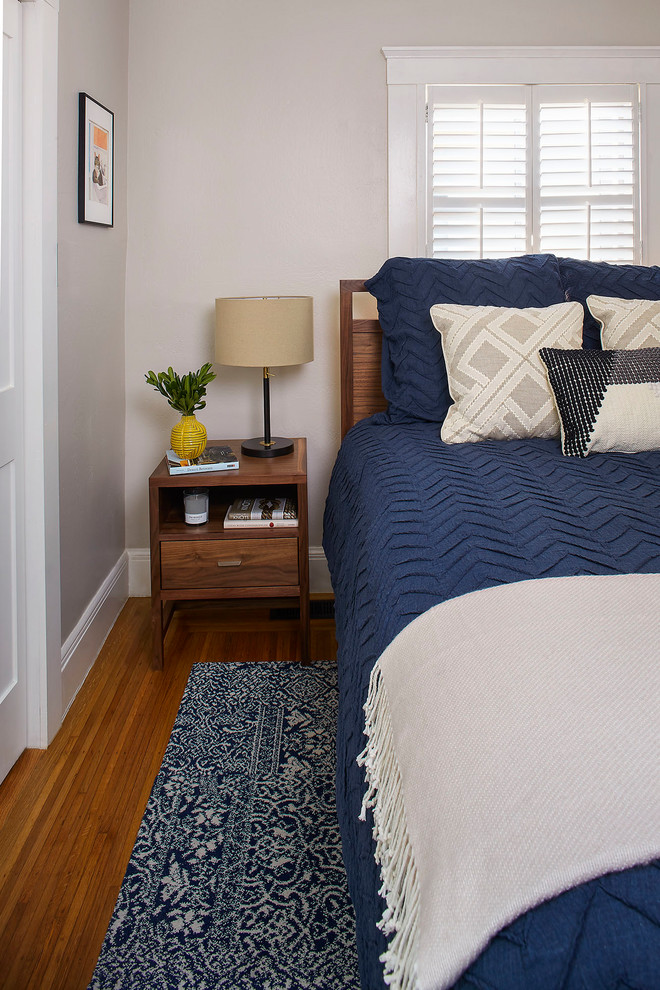 Design ideas for a small arts and crafts master bedroom in San Francisco with grey walls and medium hardwood floors.