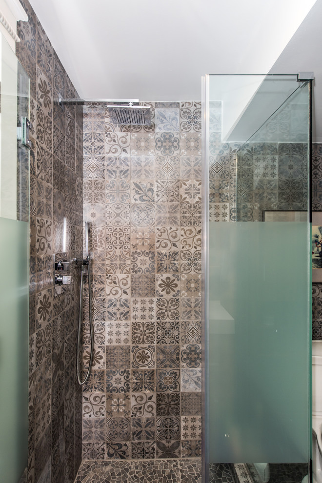 Inspiration for a mid-sized contemporary 3/4 bathroom in DC Metro with a corner shower, a two-piece toilet, gray tile, marble, grey walls, mosaic tile floors, grey floor and a hinged shower door.