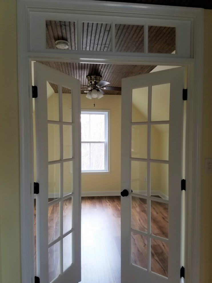 Inspiration for a large timeless loft-style vinyl floor home design remodel with yellow walls