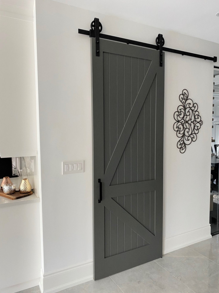 Example of a large transitional l-shaped porcelain tile and white floor open concept kitchen design in Toronto with an undermount sink, recessed-panel cabinets, white cabinets, quartz countertops, white backsplash, stone slab backsplash, stainless steel appliances, an island and white countertops