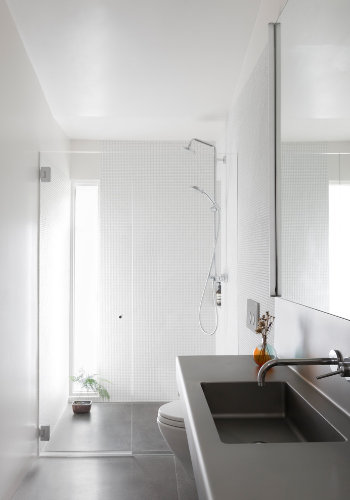 This is an example of a midcentury bathroom in Seattle with stainless steel benchtops.