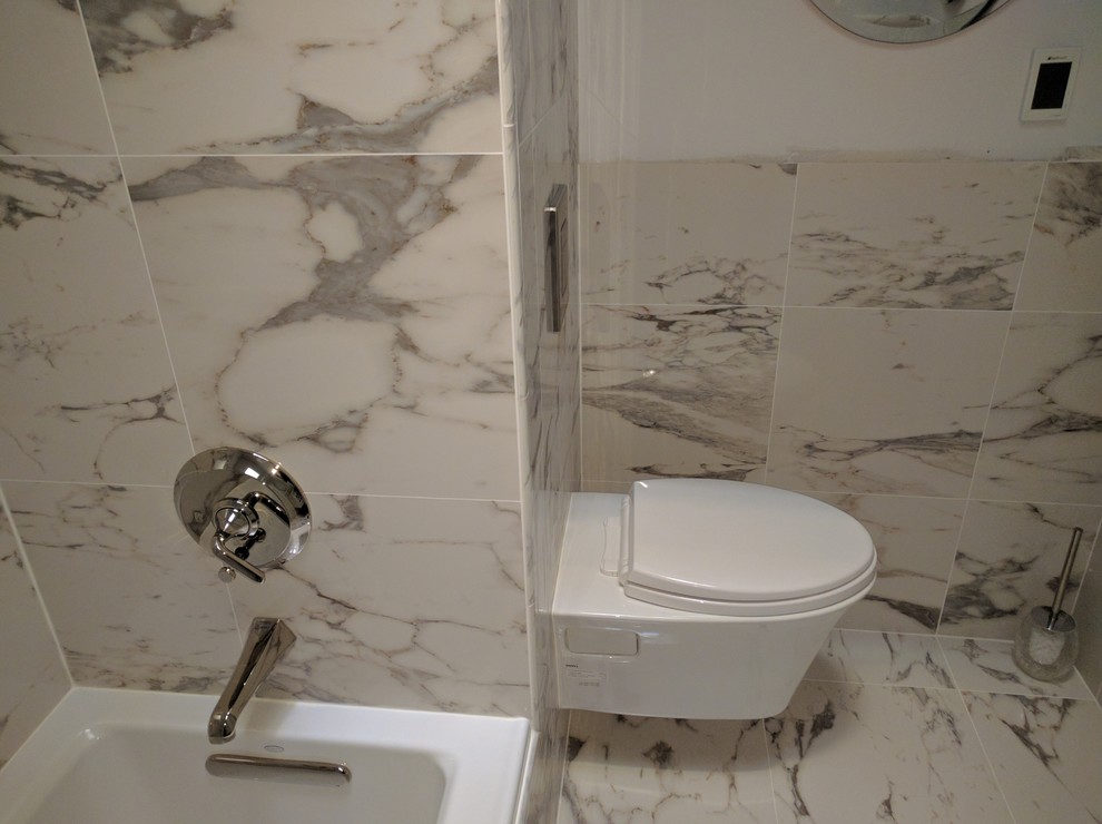 Alcove bathtub - mid-sized transitional master gray tile marble floor alcove bathtub idea in DC Metro with furniture-like cabinets, white cabinets, a wall-mount toilet, gray walls, an undermount sink and marble countertops