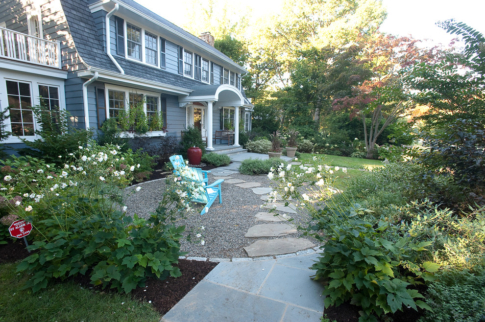 This is an example of a traditional backyard shaded garden in New York with gravel.