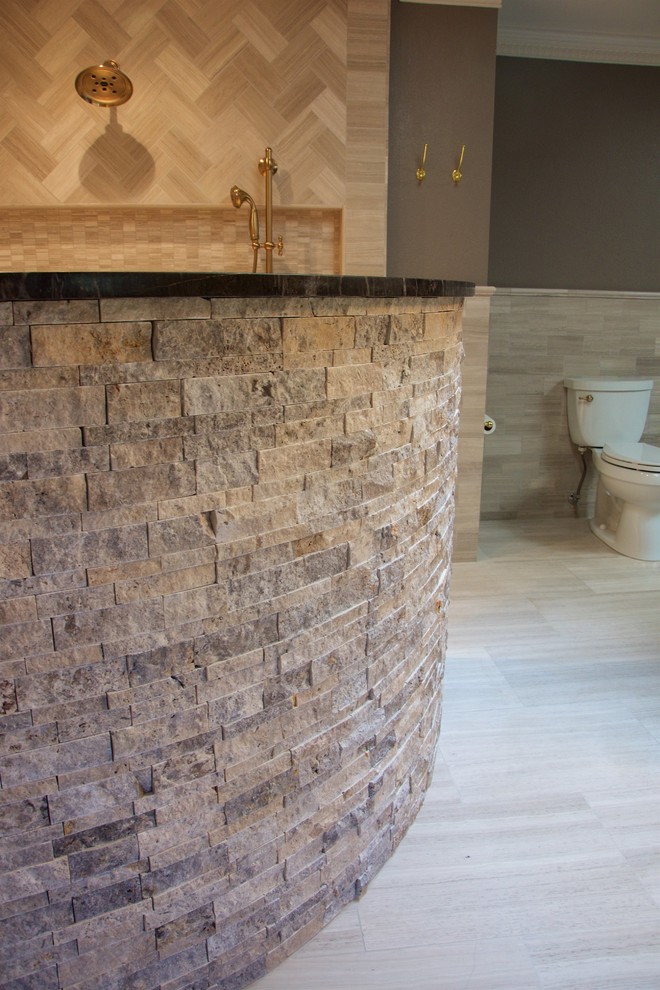 Large contemporary master bathroom in Austin with beaded inset cabinets, dark wood cabinets, a freestanding tub, an open shower, a bidet, beige tile, beige walls, ceramic floors, a drop-in sink and granite benchtops.