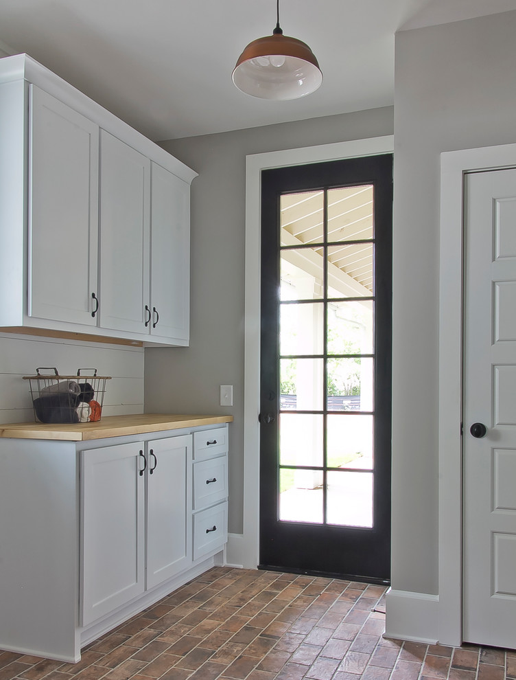 Photo of a mid-sized country utility room in Atlanta with shaker cabinets.