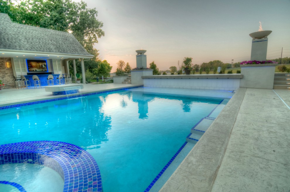 Example of a large transitional backyard concrete paver and rectangular natural hot tub design in Cedar Rapids