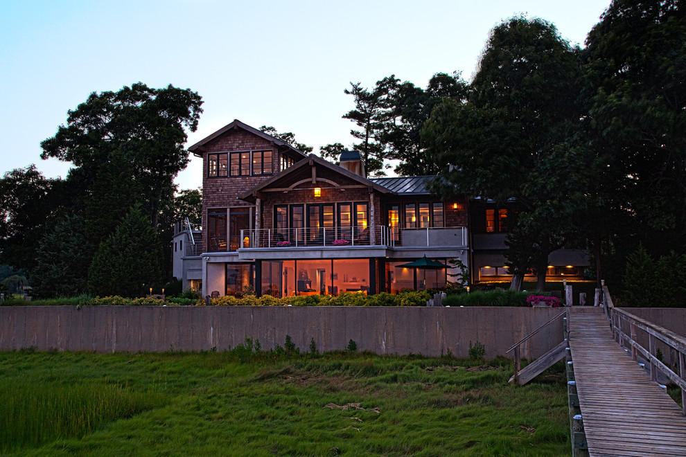Photo of an arts and crafts three-storey exterior in Boston with wood siding and a gable roof.