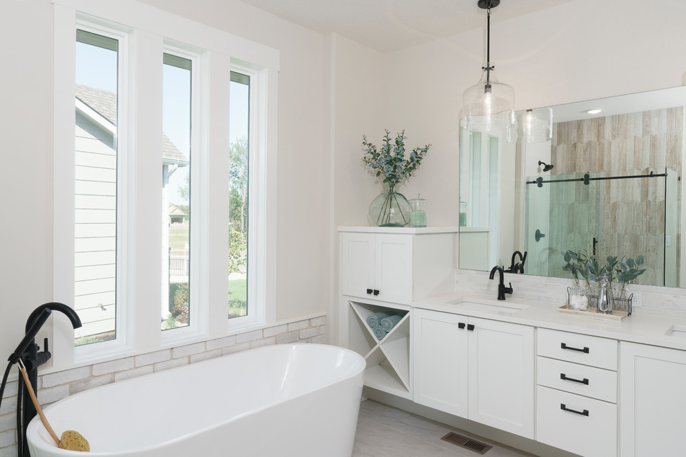 Inspiration for a large transitional master white tile and stone tile ceramic tile, beige floor and double-sink freestanding bathtub remodel in Wichita with flat-panel cabinets, white cabinets, an undermount sink, quartzite countertops, white countertops, beige walls and a built-in vanity
