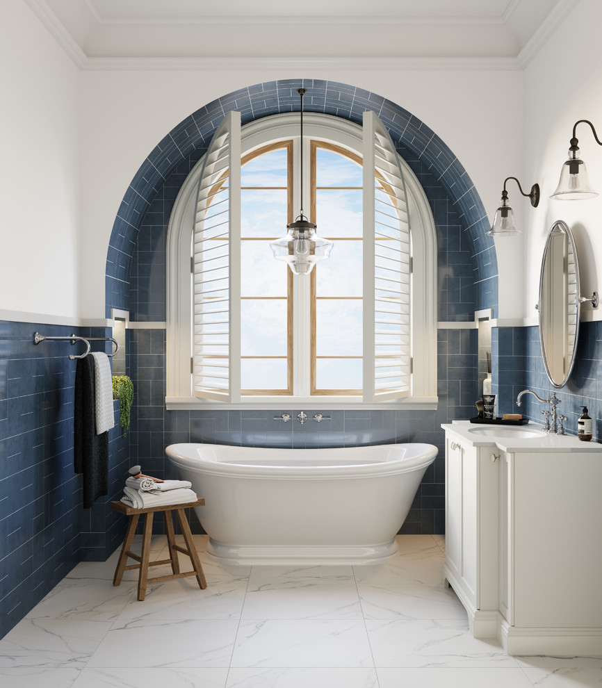 Traditional bathroom in Melbourne with white cabinets, a freestanding tub, blue tile, white walls, an undermount sink, white floor and white benchtops.