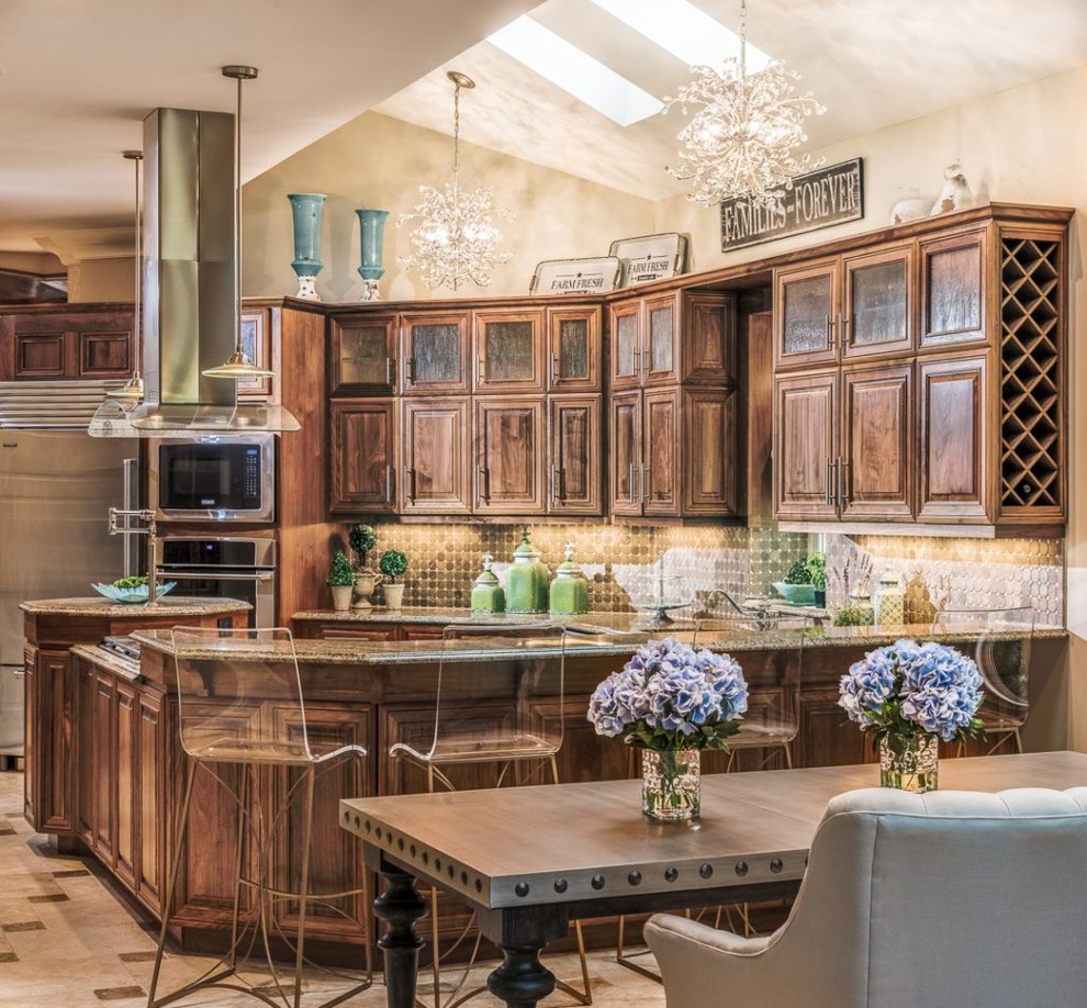 Inspiration for a traditional eat-in kitchen in Charlotte with raised-panel cabinets, dark wood cabinets, stainless steel appliances and a peninsula.