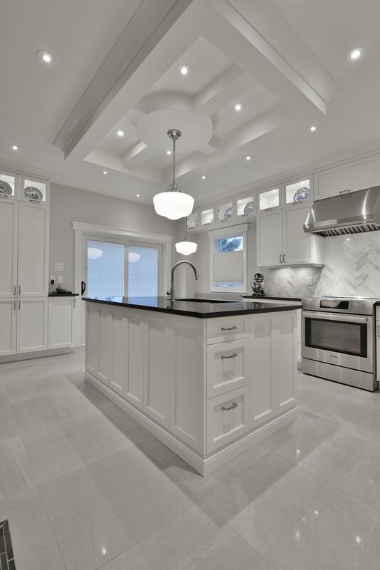 Eat-in kitchen - large transitional l-shaped ceramic tile eat-in kitchen idea in Ottawa with an undermount sink, white cabinets, granite countertops, white backsplash, stone tile backsplash, stainless steel appliances, an island and recessed-panel cabinets