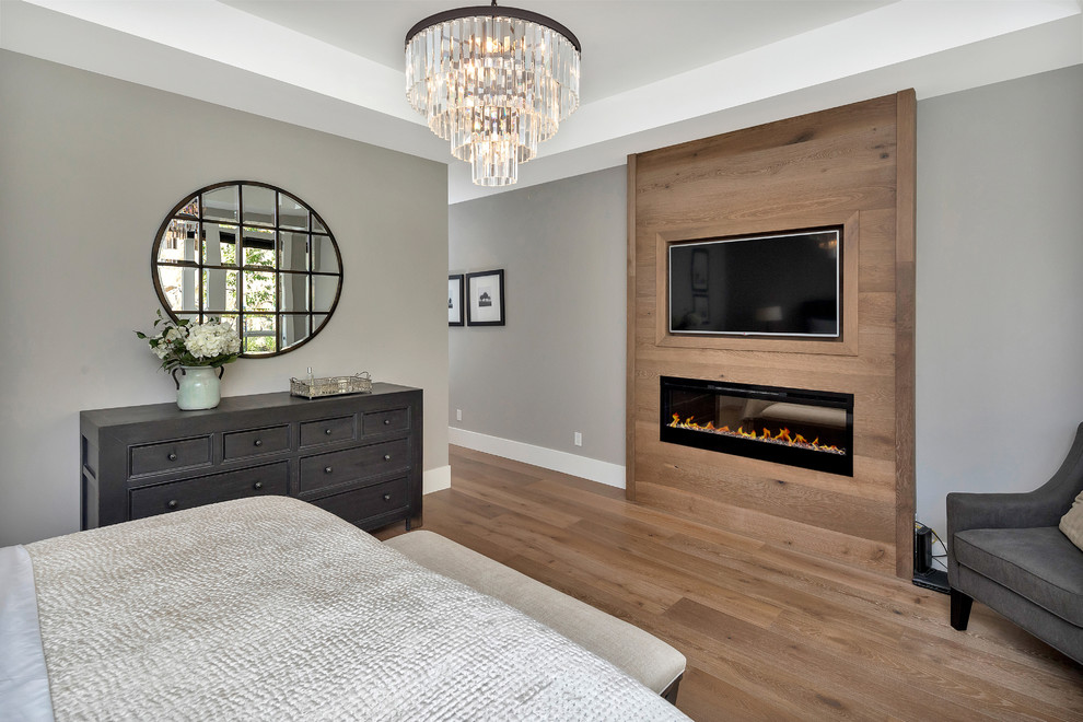 Transitional medium tone wood floor and brown floor bedroom photo