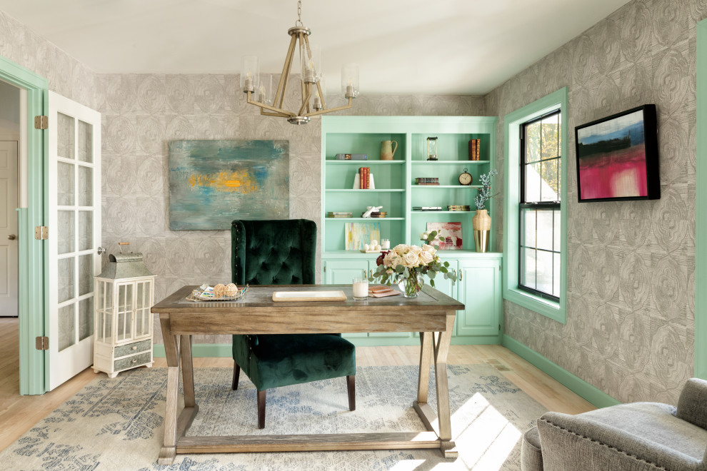 Inspiration for a transitional home office in Kansas City with multi-coloured walls, light hardwood floors, a freestanding desk, beige floor and wallpaper.