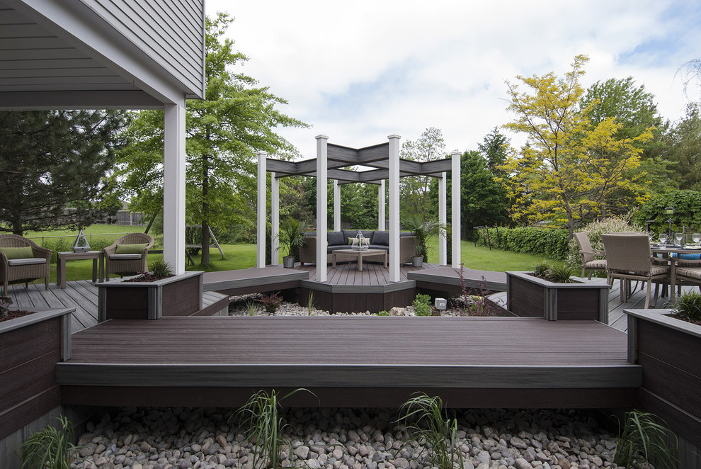 Mid-sized contemporary backyard deck in Toronto with an outdoor kitchen and a pergola.