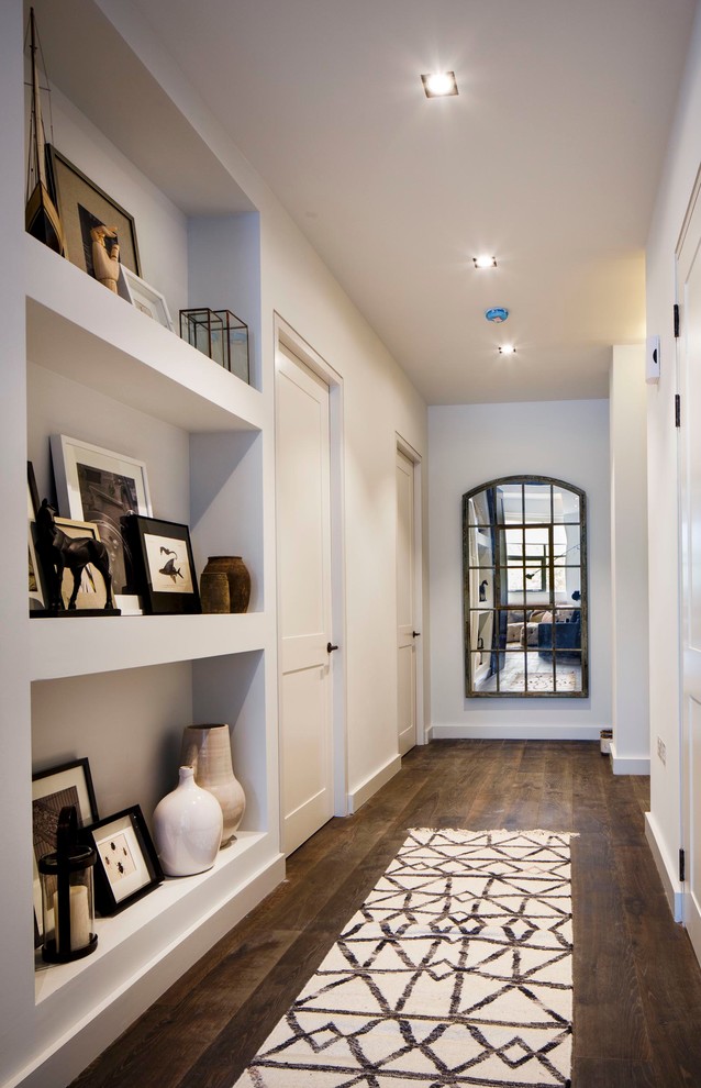Design ideas for an expansive contemporary hallway in London with white walls and dark hardwood floors.