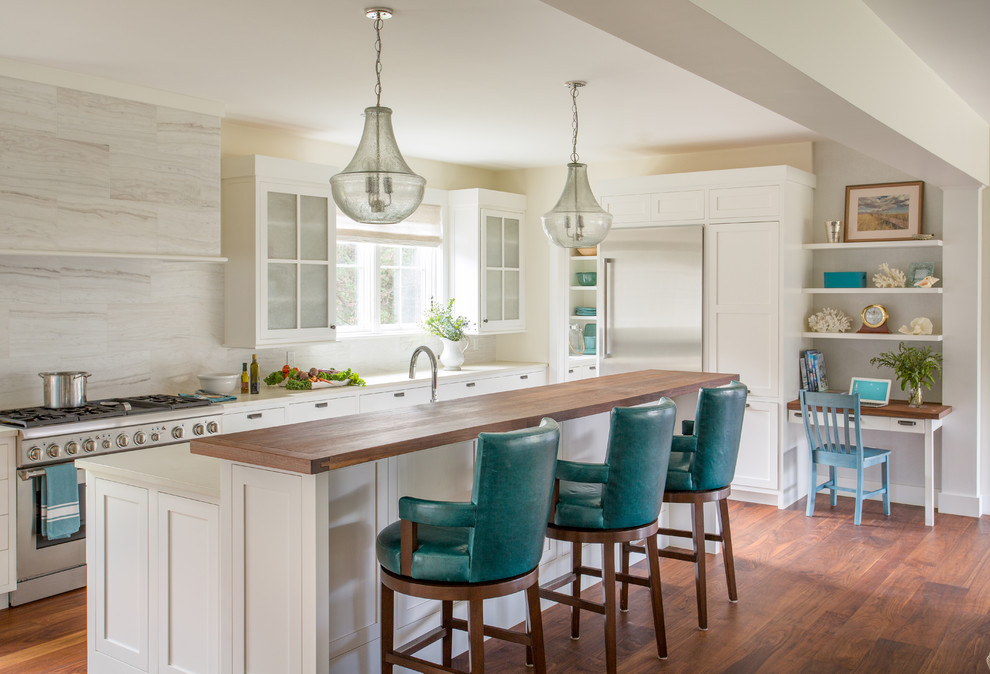 Photo of a large beach style galley open plan kitchen in Boston with white cabinets, with island, shaker cabinets, quartz benchtops, brown splashback, marble splashback, stainless steel appliances, dark hardwood floors, brown floor and white benchtop.