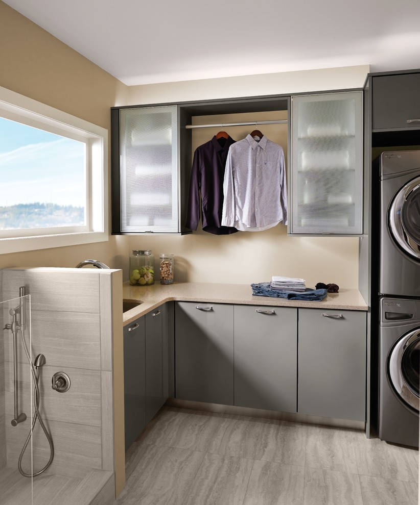 Design ideas for a contemporary l-shaped laundry room in Detroit with flat-panel cabinets, grey cabinets, an undermount sink and beige walls.