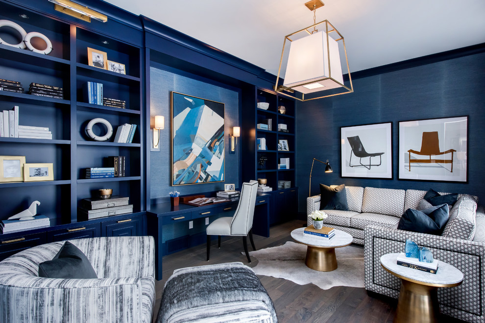 Photo of a transitional study room in Other with blue walls, dark hardwood floors, no fireplace and a built-in desk.