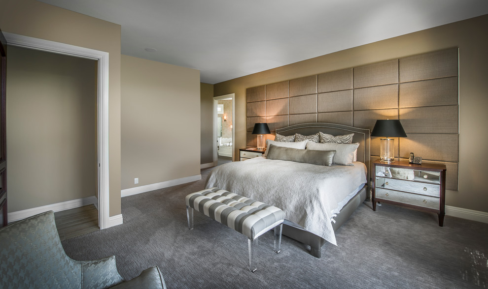 Photo of a transitional master bedroom in Omaha with beige walls and carpet.