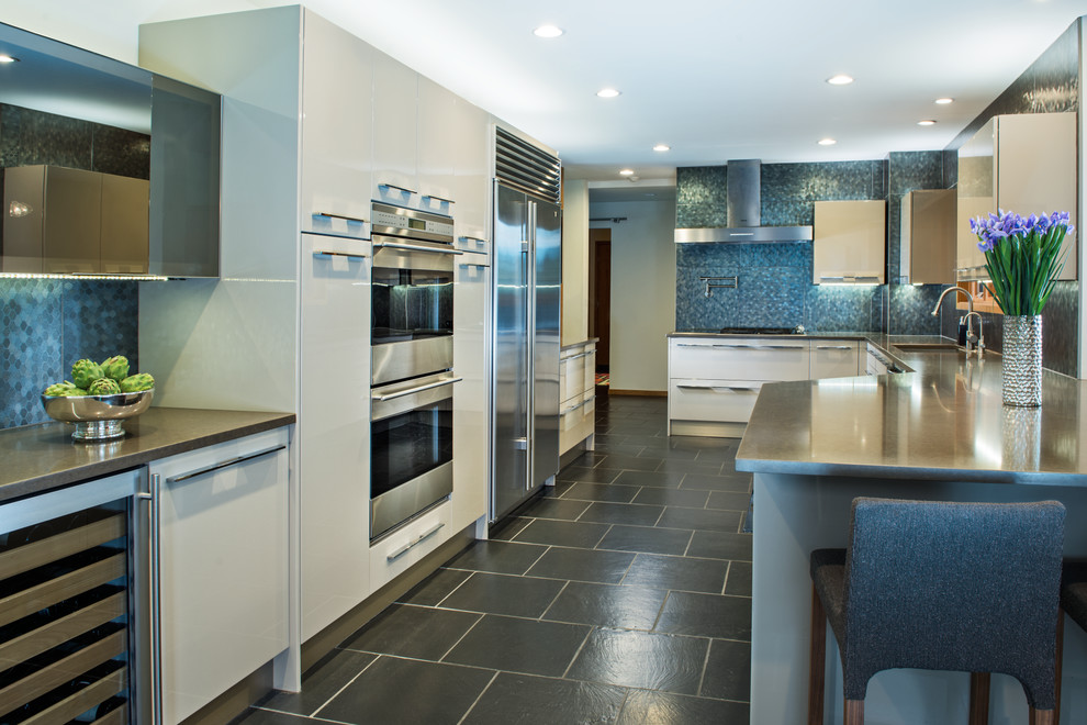 Design ideas for a large contemporary galley separate kitchen in Detroit with an undermount sink, flat-panel cabinets, beige cabinets, blue splashback, stone tile splashback, stainless steel appliances, no island, slate floors and concrete benchtops.