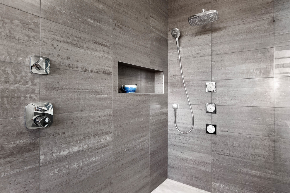 Large contemporary master bathroom in Seattle with flat-panel cabinets, black cabinets, a freestanding tub, a curbless shower, gray tile, porcelain tile, grey walls, porcelain floors, an undermount sink, engineered quartz benchtops, grey floor, an open shower and white benchtops.
