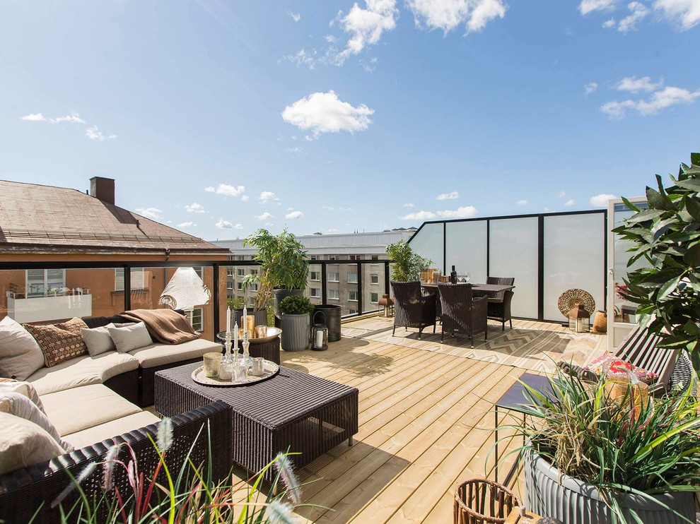 This is an example of a large contemporary rooftop and rooftop deck in Stockholm with a container garden and no cover.