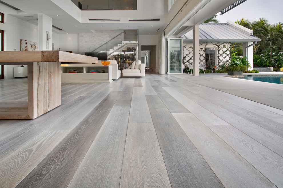 Example of a large trendy open concept medium tone wood floor living room design in Miami