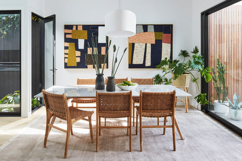 Inspiration for a contemporary dining room in Melbourne with white walls, light hardwood floors and no fireplace.