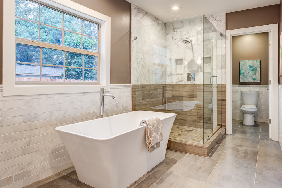 Freestanding bathtub - mid-sized traditional master white tile and stone tile ceramic tile freestanding bathtub idea in Sacramento with an undermount sink, furniture-like cabinets, white cabinets, marble countertops, a two-piece toilet and brown walls