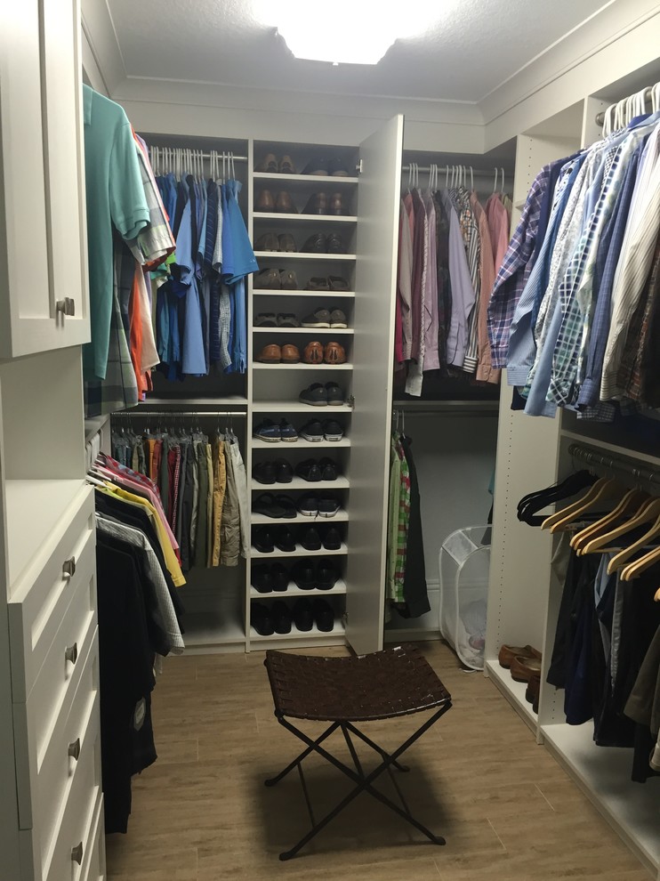 Mid-sized transitional gender-neutral walk-in wardrobe in Miami with shaker cabinets, white cabinets and porcelain floors.