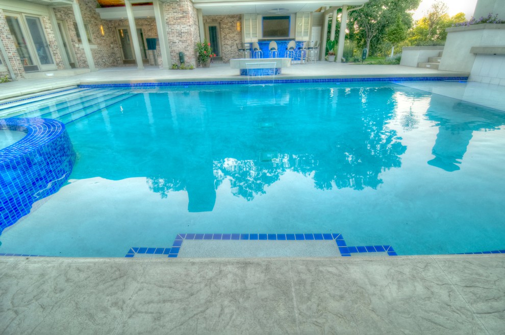 Large transitional backyard concrete paver and rectangular natural hot tub photo in Cedar Rapids